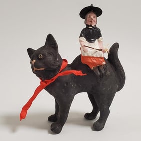 Antique 5 3/4" German papier-mache black cat candy container with witch riding on back (leg