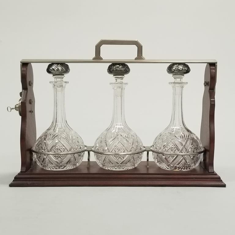 Antique cut glass tantalus with silver stoppers - 19" wide x 7" deep x 13 1/2" high: Antique cut glass tantalus with silver stoppers - 19" wide x 7" deep x 13 1/2" high (1 decanter & 2 stoppers chipped)