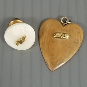 2 gold nugget jewelry items: one carved heart pendant & one lapel pin