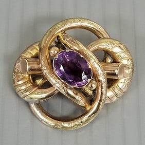 Antique Victorian pinchbeck lover's knot brooch set w/ faceted amethyst - 1 3/4"