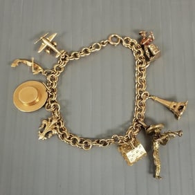 14k gold charm bracelet w/ 8 gold charms, 9k to 18k - 21.2 grams total, 7"L