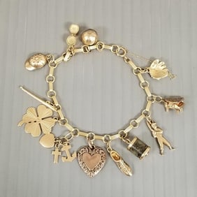14k gold charm bracelet w/ 12 charms; 7 marked 14k - 12.3 grams total, approx. 6 1/4"L