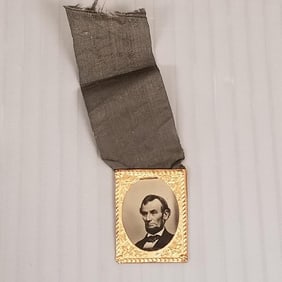 President Lincoln mourning ribbon with tin type photo- 1"H 3/4"W tin type with frame; 2"L ribbon