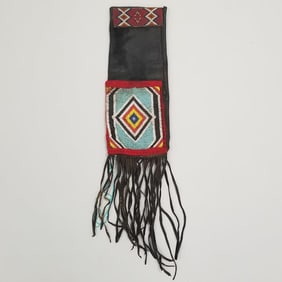 Leather fringe pipe bag with applied beadwork decoration- approx. 29" x 7" OD including fringe
