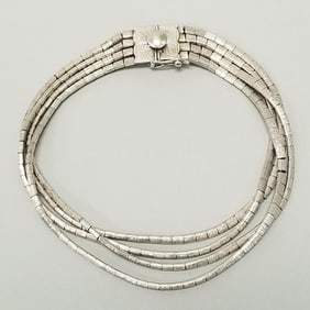 4-strand 18K white gold bracelet: 28.3 grams (some minor link spaces) 7 1/2"L 3/8"W