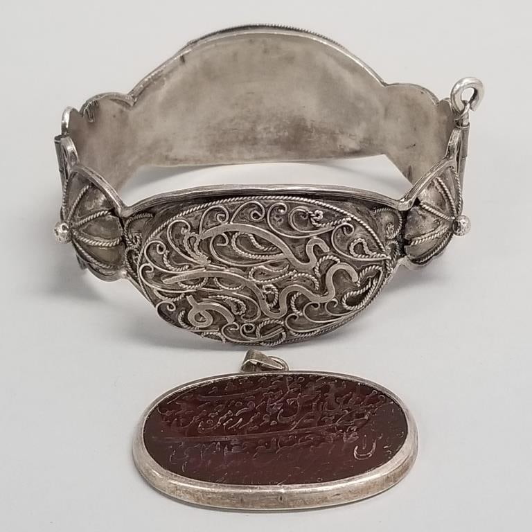 2 pcs. vintage ethnic jewelry: hinged cuff & engraved stone pendant- 50.9 grams total, 7 1/4" int.: 2 pcs. vintage ethnic jewelry: hinged cuff & engraved stone pendant- 50.9 grams total, 7 1/4" int. circ., pendant 1 3/4"L