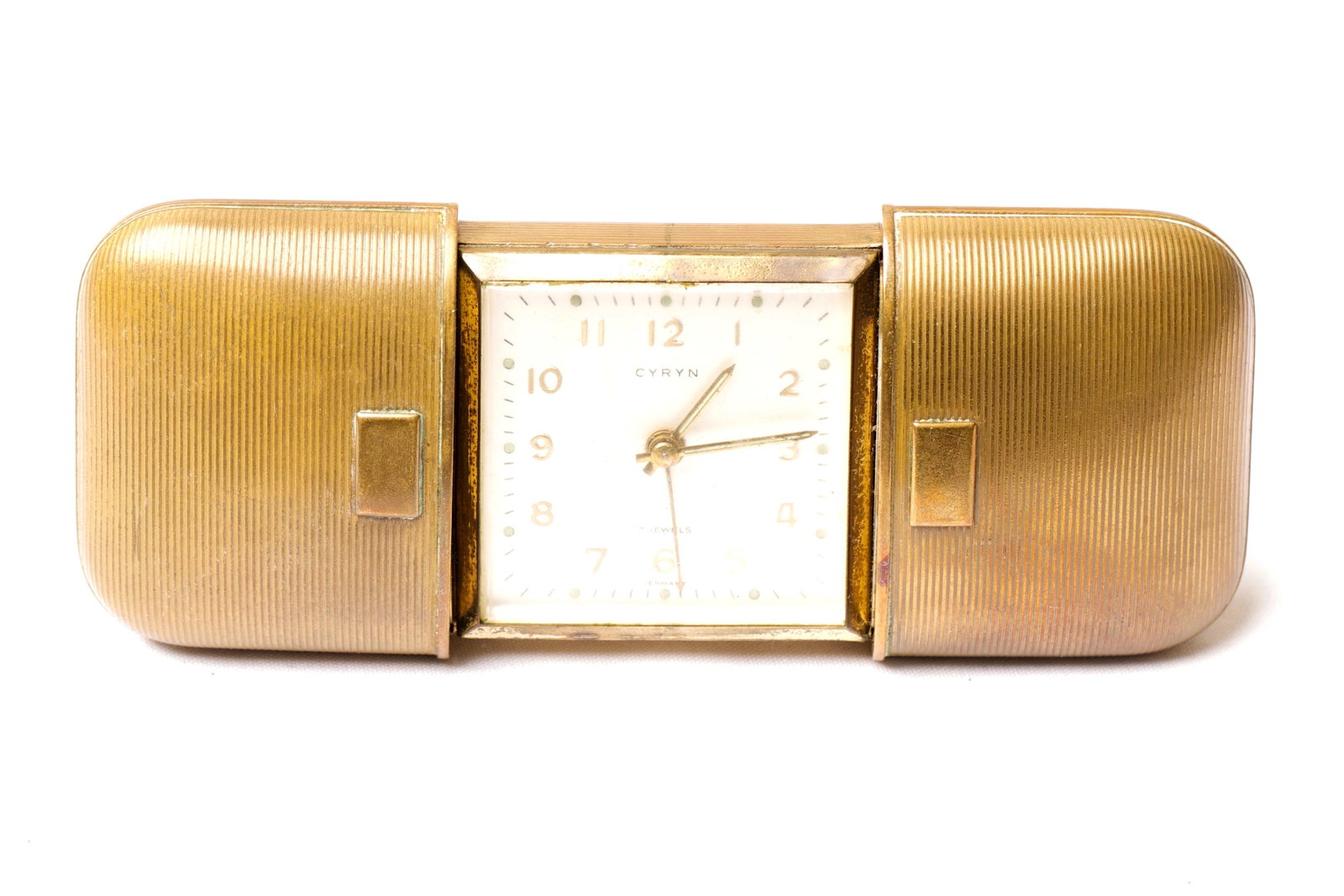 CYRYN 7 Jewels German Travel Clock: Folding CYRYN 7 Jewels German Travel Clock. Dimensions: 6.5 x 10.5cm, Fully expanded length 16.5cm Quantity: 1 Condition: Working Width: 6.5cm or approximately 2.56 inches Depth: 10.5cm or