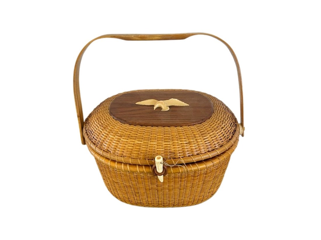 Vintage Nantucket Basket Purse with Bird, Signed, 1977: 12in. w x 9.5in. d x 7in. h, Handle: 12in. PLEASE READ BEFORE BIDDING: There are two scheduled pickup dates for this auction at our Stamford, CT warehouse: Friday, April 24th from 9:00 AM–12:00 PM