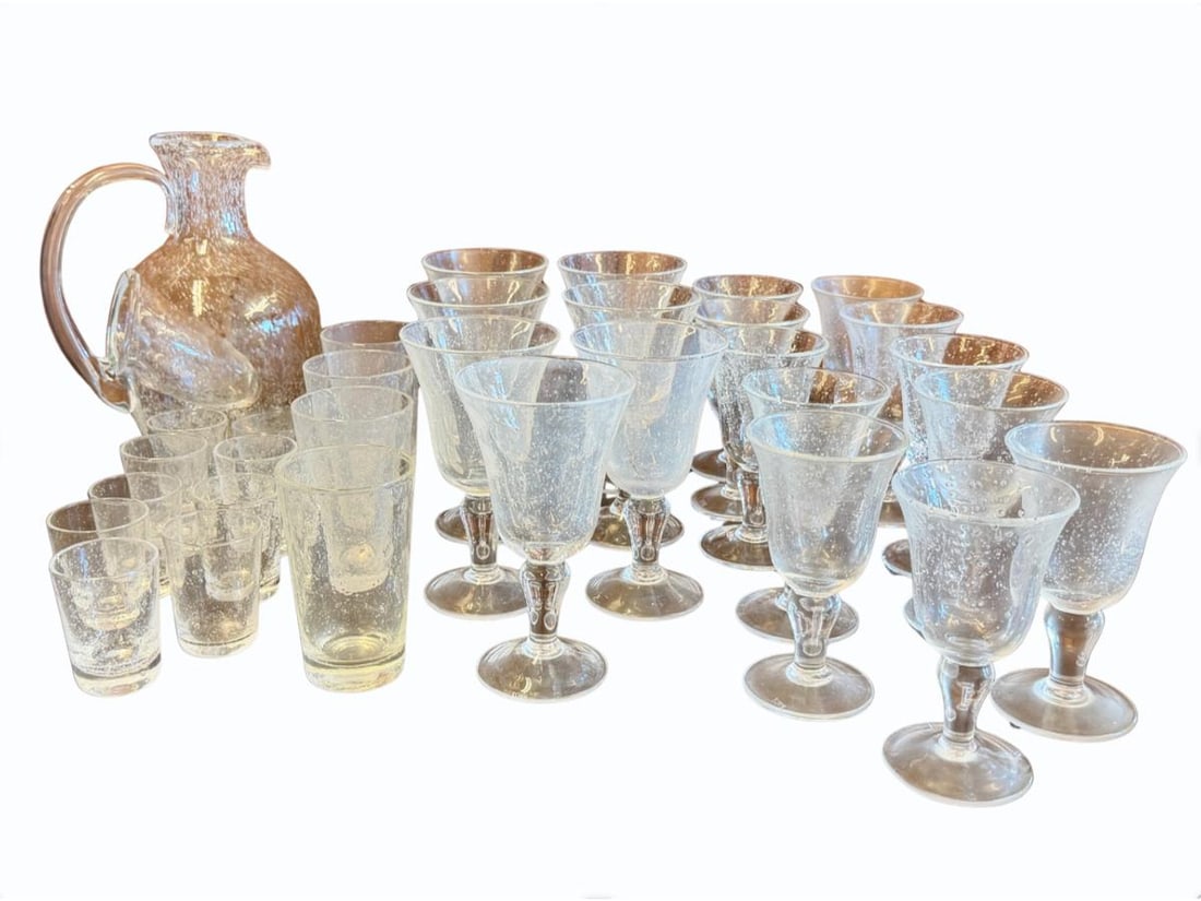 Verrerie de Biot Glassware in Clear, Collection of 32: Collection includes 1 large Carafe with internal ice reservoir - 8.5in w x 6in d x 10in h, 11- 6in white wine goblets, 7 - 7in water goblets, 4 - 5in juice glasses, 9 - 3in shot glasses
