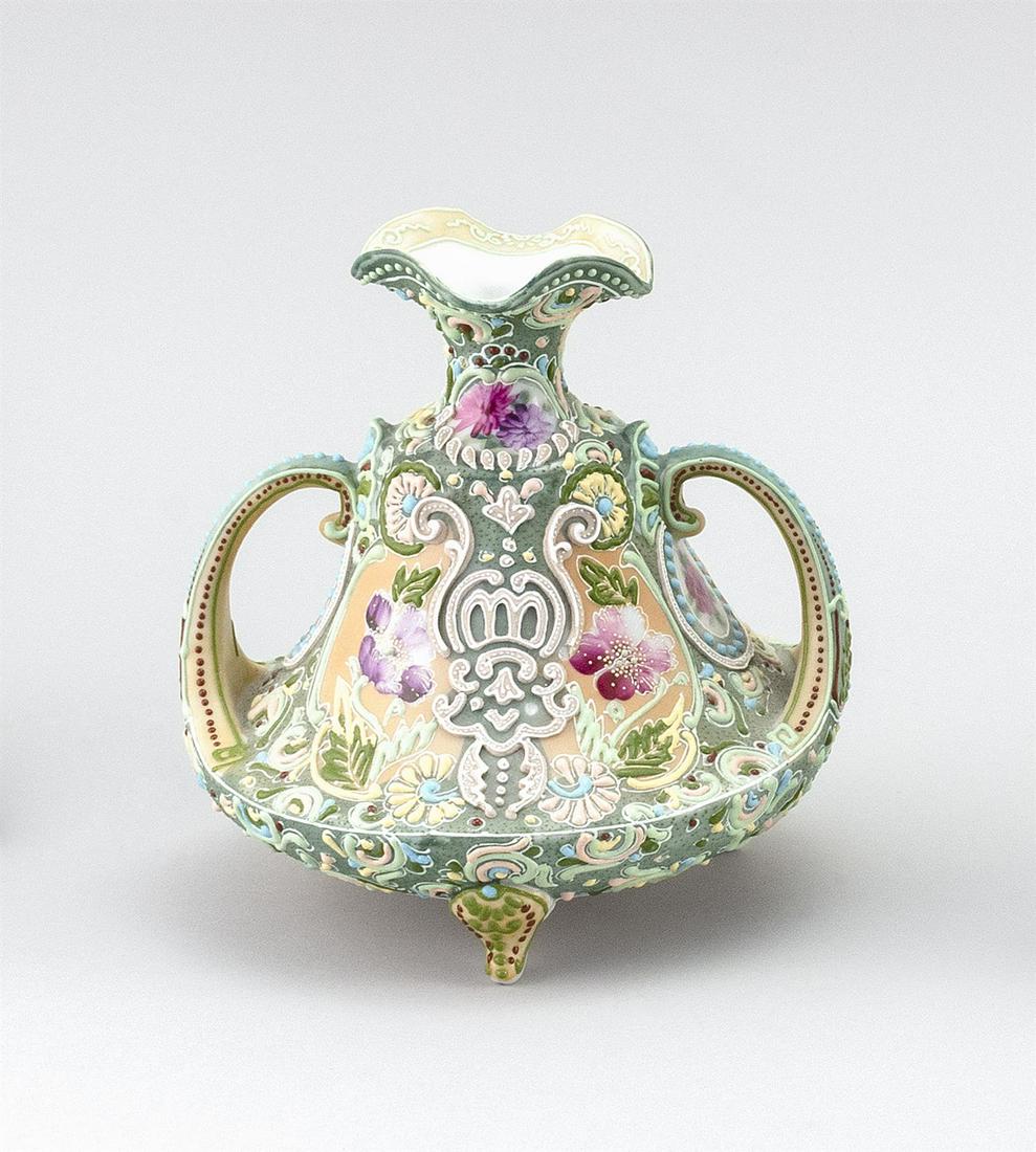 MORIAGE NIPPON PORCELAIN FOOTED VASE In bell form, with: MORIAGE NIPPON PORCELAIN FOOTED VASE In bell form, with crescent-shaped handles, tripod base and floral decoration. Height 6.75".