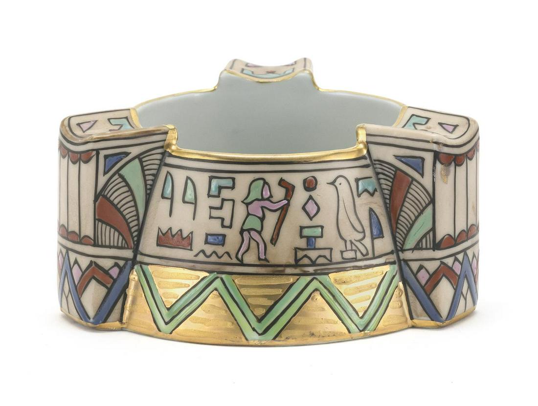 NIPPON PORCELAIN ASHTRAY Circular, with three handles: NIPPON PORCELAIN ASHTRAY Circular, with three handles and decoration of Egyptian motifs. Diameter 4.5".