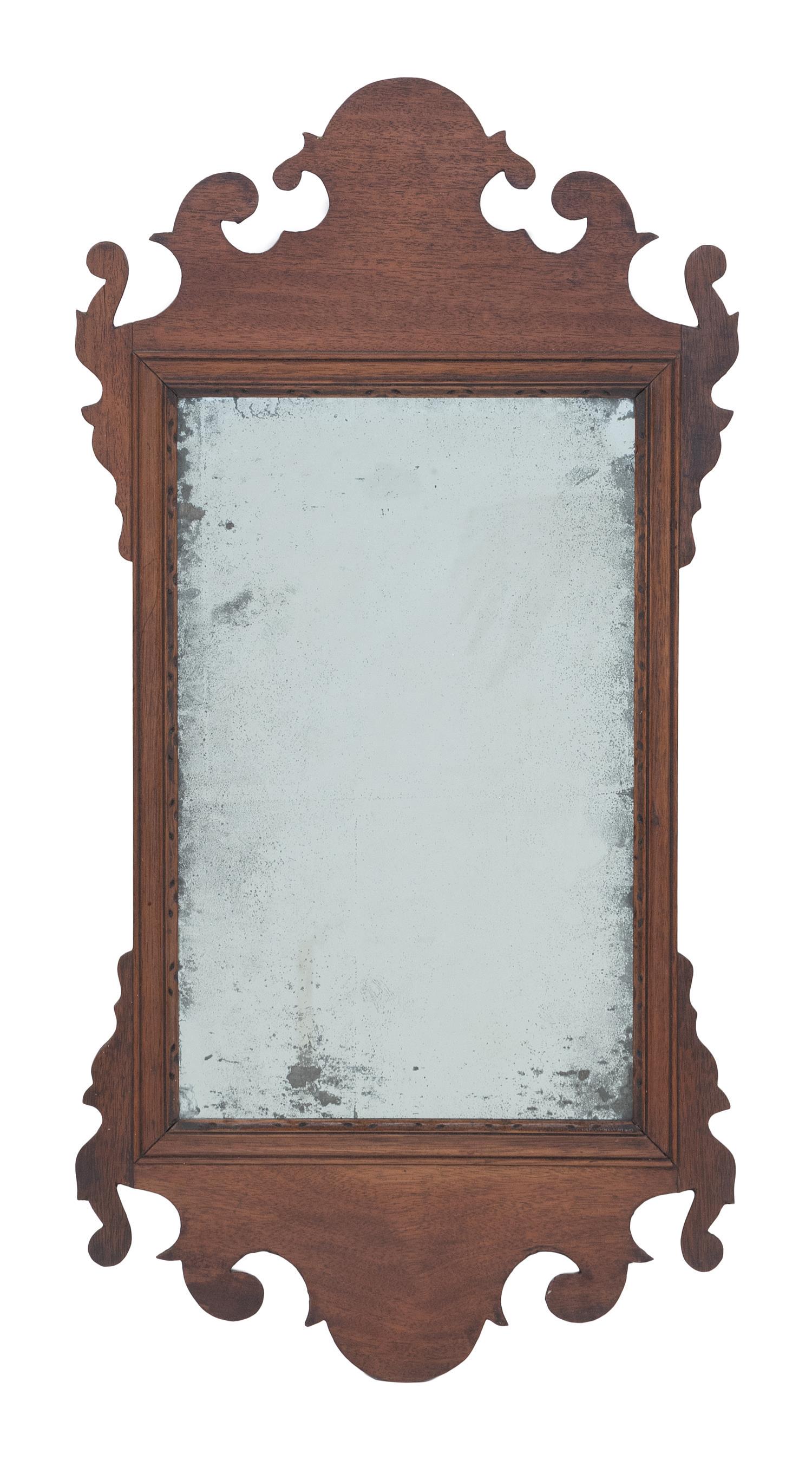CHIPPENDALE MIRROR Mahogany frame with nicely scrolled: CHIPPENDALE MIRROR America, Late 18th Century Mahogany frame with nicely scrolled ears and crest. Height 28". Width 14.25".