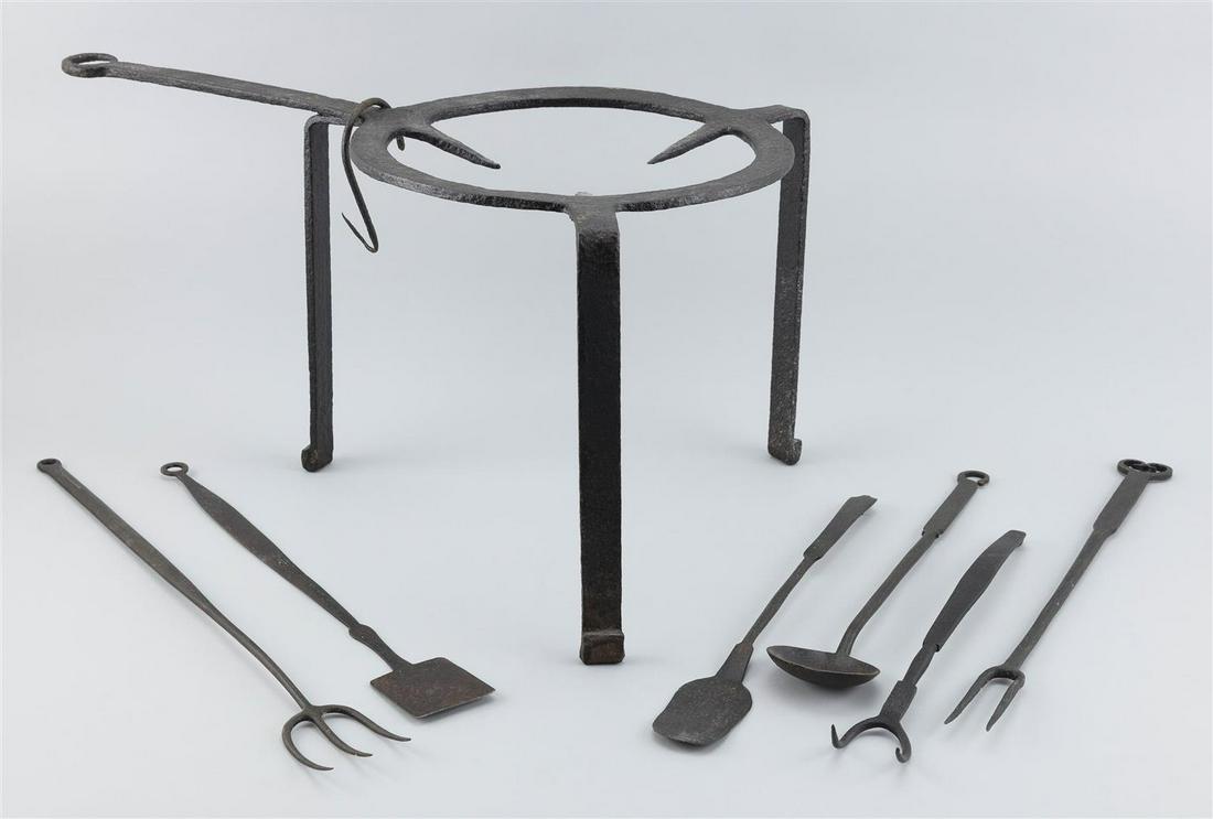SEVEN PIECES OF WROUGHT IRON KITCHENWARE A trivet,: SEVEN PIECES OF WROUGHT IRON KITCHENWARE 18th Century A trivet, height 12.5" and length 24", and three cooking forks, a spoon and two small peels, lengths from 14.5" to 22".
