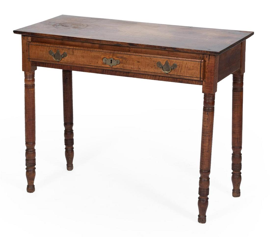 DRESSING TABLE In tiger maple. One drawer with brass: DRESSING TABLE 19th Century In tiger maple. One drawer with brass bail pulls. Turned legs end in knob feet. Height 29". Width 36". Depth 16".