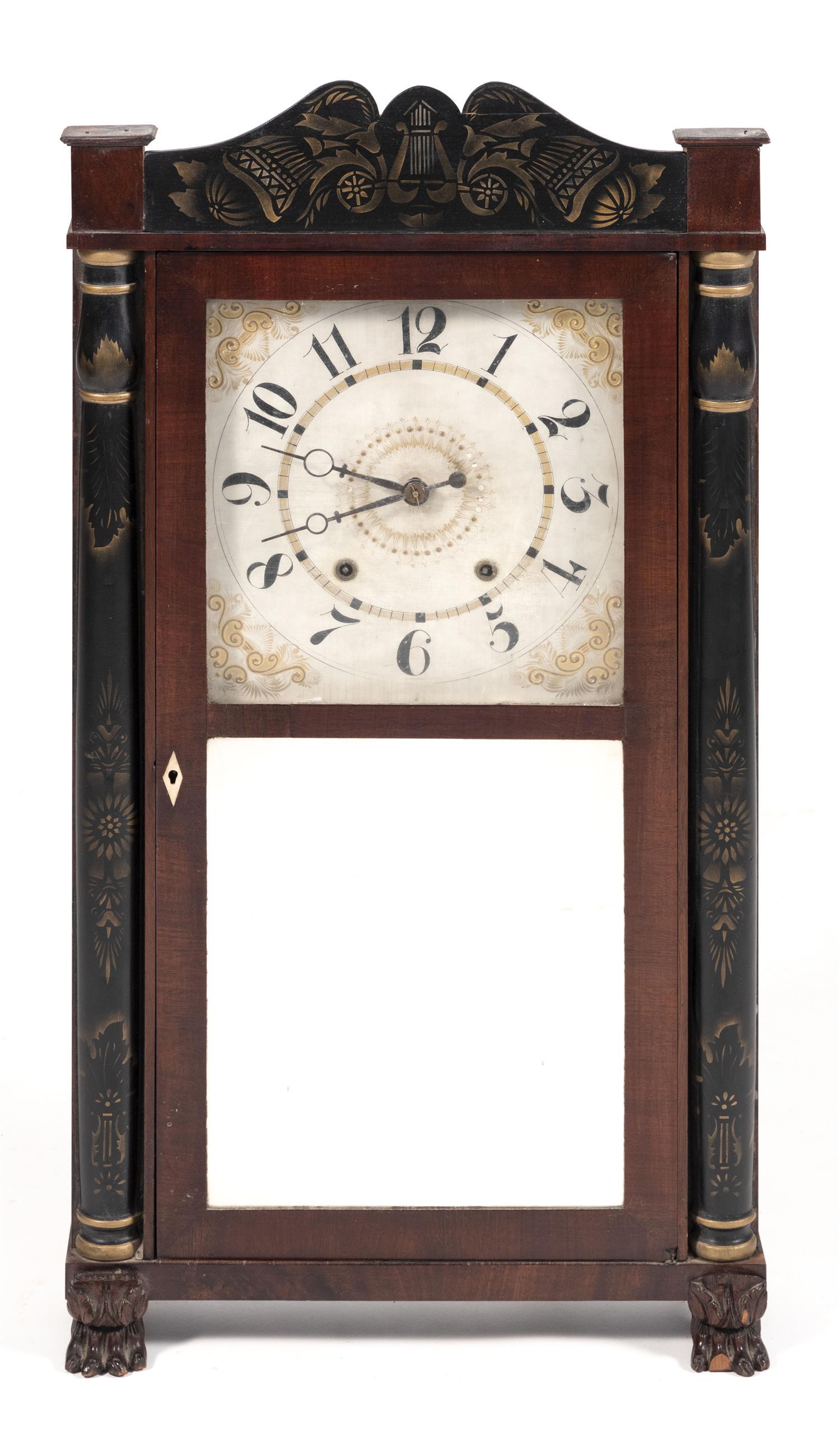 ELI TERRY EMPIRE SHELF CLOCK Mahogany and mahogany: ELI TERRY EMPIRE SHELF CLOCK Connecticut, Second Quarter of the 19th Century Mahogany and mahogany veneer case with stenciled crest, carved half columns at sides and carved paw feet. Mirrored lower do