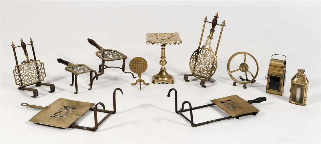 ELEVEN ASSORTED BRASS AND WROUGHT IRON ITEMS 19th: ELEVEN ASSORTED BRASS AND WROUGHT IRON ITEMS 19th Century Eight trivets, two with Masonic decoration, a doll's tilt-top stand with checkerboard decoration on top, and two skater's lanterns. Heights fr