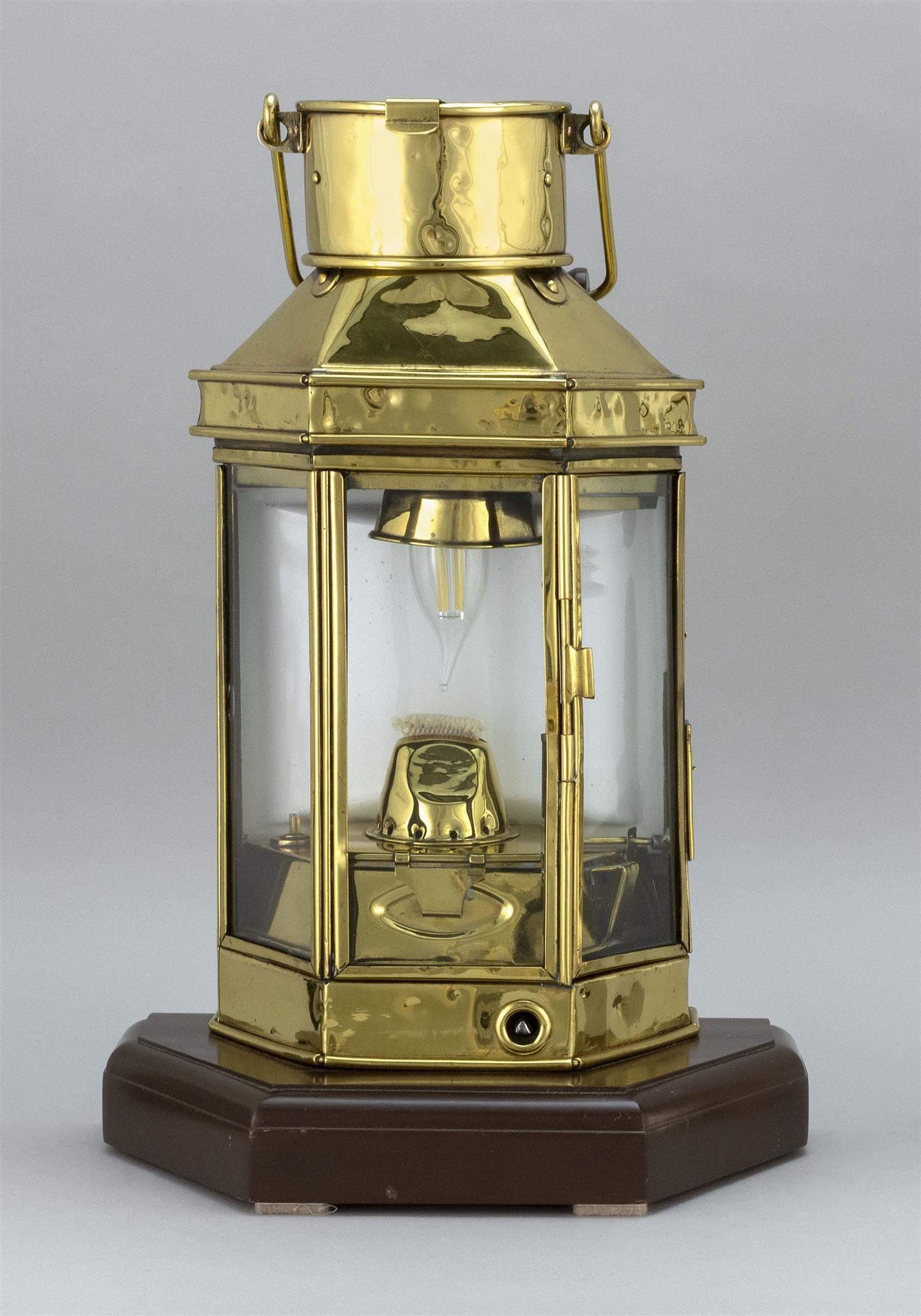 BRASS BULPITT SHIP'S CABIN LANTERN Late 19th Century: BRASS BULPITT SHIP'S CABIN LANTERN Late 19th Century Highly polished and lacquered. Swing handle at top. Mounted on a later wooden base and electrified. Total height 17.5".