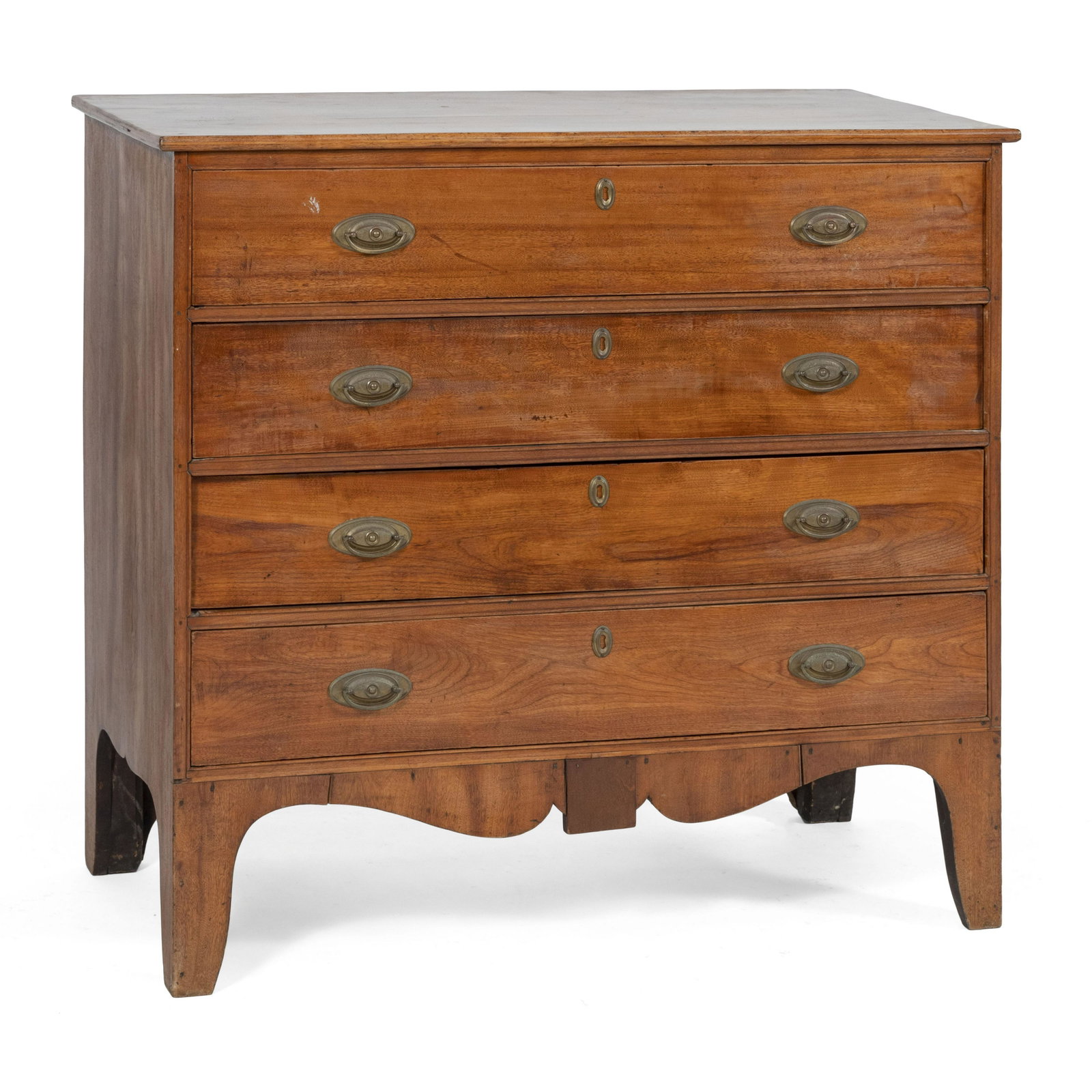 HEPPLEWHITE CHEST OF DRAWERS Early 19th Century: HEPPLEWHITE CHEST OF DRAWERS Early 19th Century In butternut. Four full-width drawers with oval brass pulls. Shaped apron with contrasting mahogany central panel. Tall French feet. Height 38.75". Widt