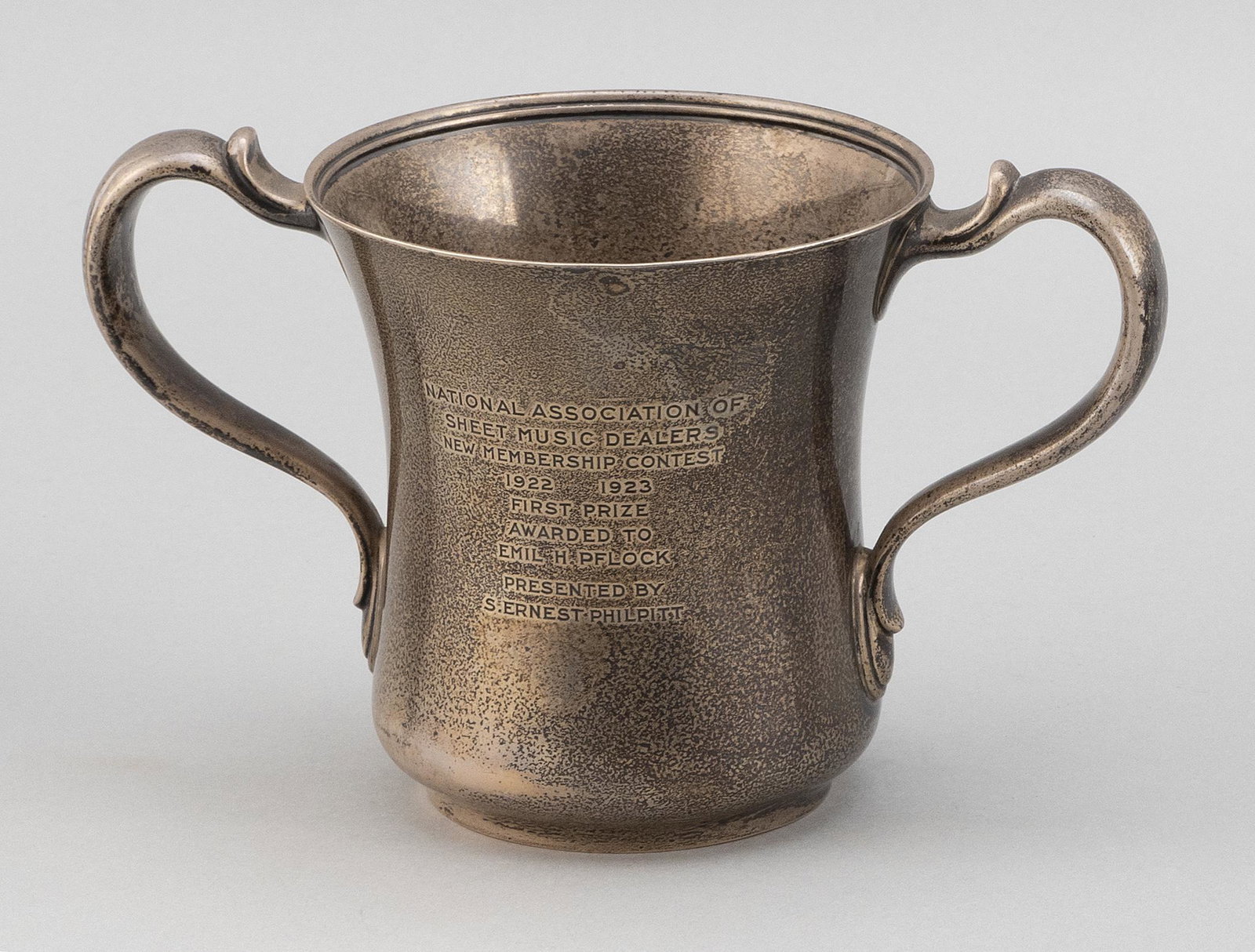 TIFFANY & CO. STERLING SILVER TROPHY New York, Circa: TIFFANY & CO. STERLING SILVER TROPHY New York, Circa 1923 With presentation inscription pertaining to the National Association of Sheet Music Dealers. Height 5.25". Approx. 13.3 troy oz.