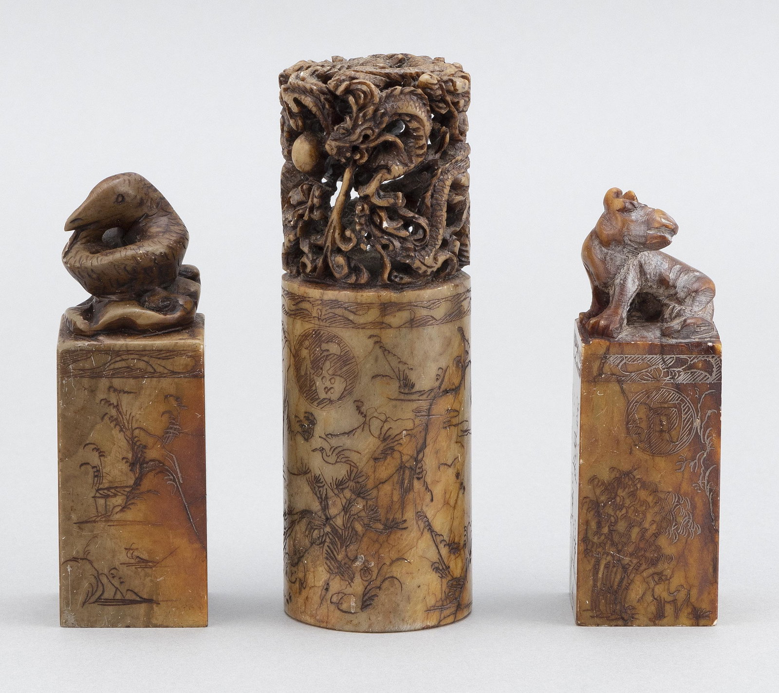THREE CHINESE UNCUT CARVED SOAPSTONE SEALS Late 19th: THREE CHINESE UNCUT CARVED SOAPSTONE SEALS Late 19th Century Largest with dragon motif and two smaller with animal motifs. Heights 3.5" and 5".