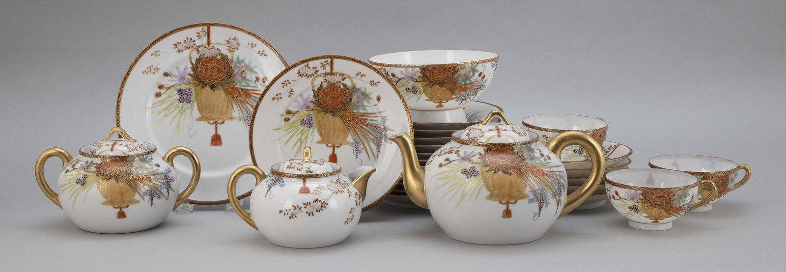 JAPANESE PORCELAIN TEA SERVICE Early 20th Century: JAPANESE PORCELAIN TEA SERVICEEarly 20th CenturyIncludes a teapot, height 4.5", a creamer and sugar, heights 4", a waste bowl, diameter 6", three cups, four saucers, twelve luncheon pla