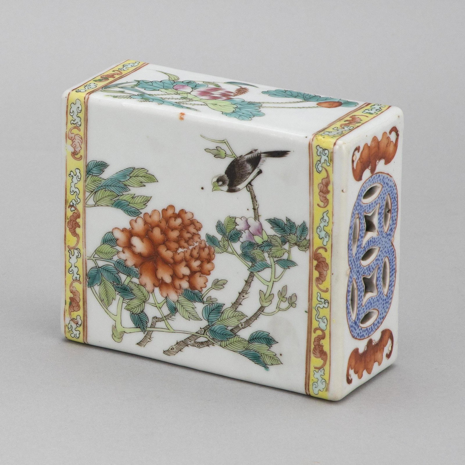 CHINESE POLYCHROME PORCELAIN PILLOW Late 19th/Early: CHINESE POLYCHROME PORCELAIN PILLOW Late 19th/Early 20th Century Rectangular, with decoration on obverse and reverse of a bird on a flowering tree branch, with a bat and cloud border and an openwork d