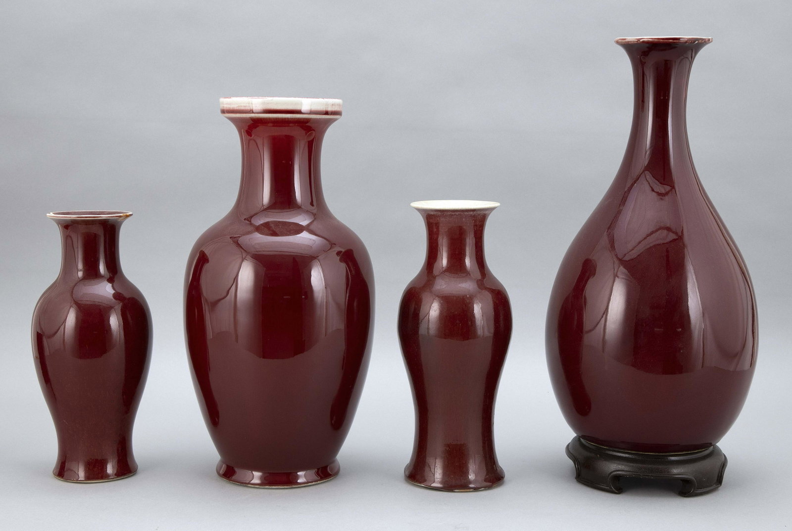 FOUR CHINESE SANG DE BOEUF PORCELAIN VASES 19th-20th: FOUR CHINESE SANG DE BOEUF PORCELAIN VASES 19th-20th Century In baluster form. Two marked on base. One mounted on a wooden base. Heights from 10" to 17".