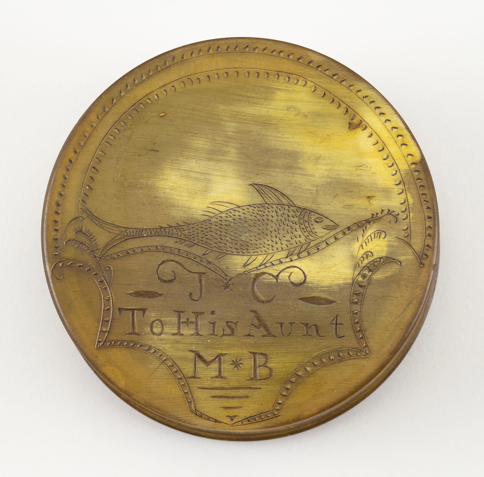 HORN SNUFF BOX WITH SCRIMSHAW-STYLE ENGRAVING 19th: HORN SNUFF BOX WITH SCRIMSHAW-STYLE ENGRAVING 19th Century One face engraved with a fish above "J*C To His Aunt M*B", surrounded by foliate and pique borders. Sawtooth and pique border on ed
