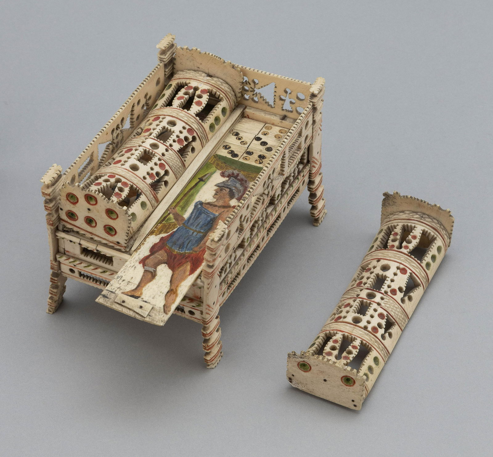NAPOLEONIC PRISONER-OF-WAR POLYCHROME CARVED BONE GAMES: NAPOLEONIC PRISONER-OF-WAR POLYCHROME CARVED BONE GAMES BOXFrench/English, Early 19th CenturyRectangular splay-legged box with pierced and carved panels and two domed lids, all in a matching geometric