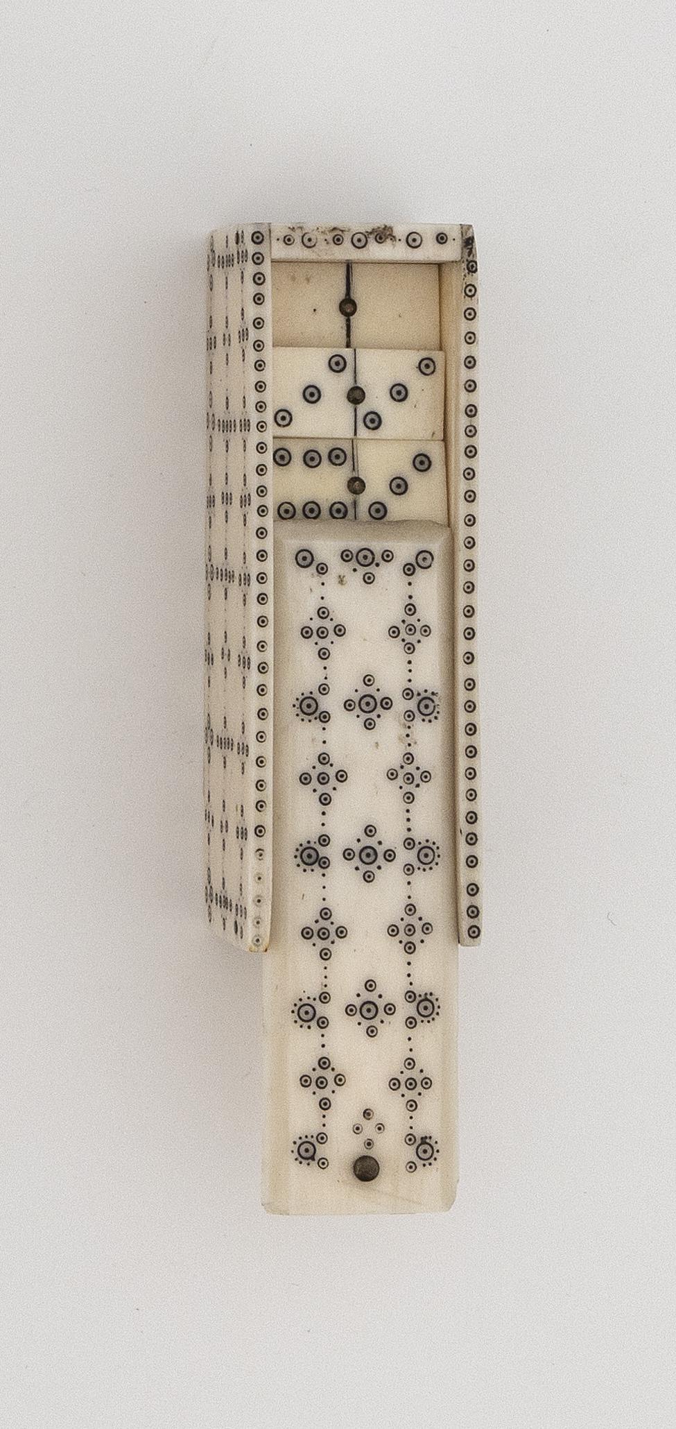 PRISONER-OF-WAR BONE GAMES BOX, PROBABLY RUSSIAN 19th: PRISONER-OF-WAR BONE GAMES BOX, PROBABLY RUSSIAN 19th Century Sliding lid and sides of box with circle and dot design in a floriform pattern. Contains 27 bone dominoes with a brass pin at center and p