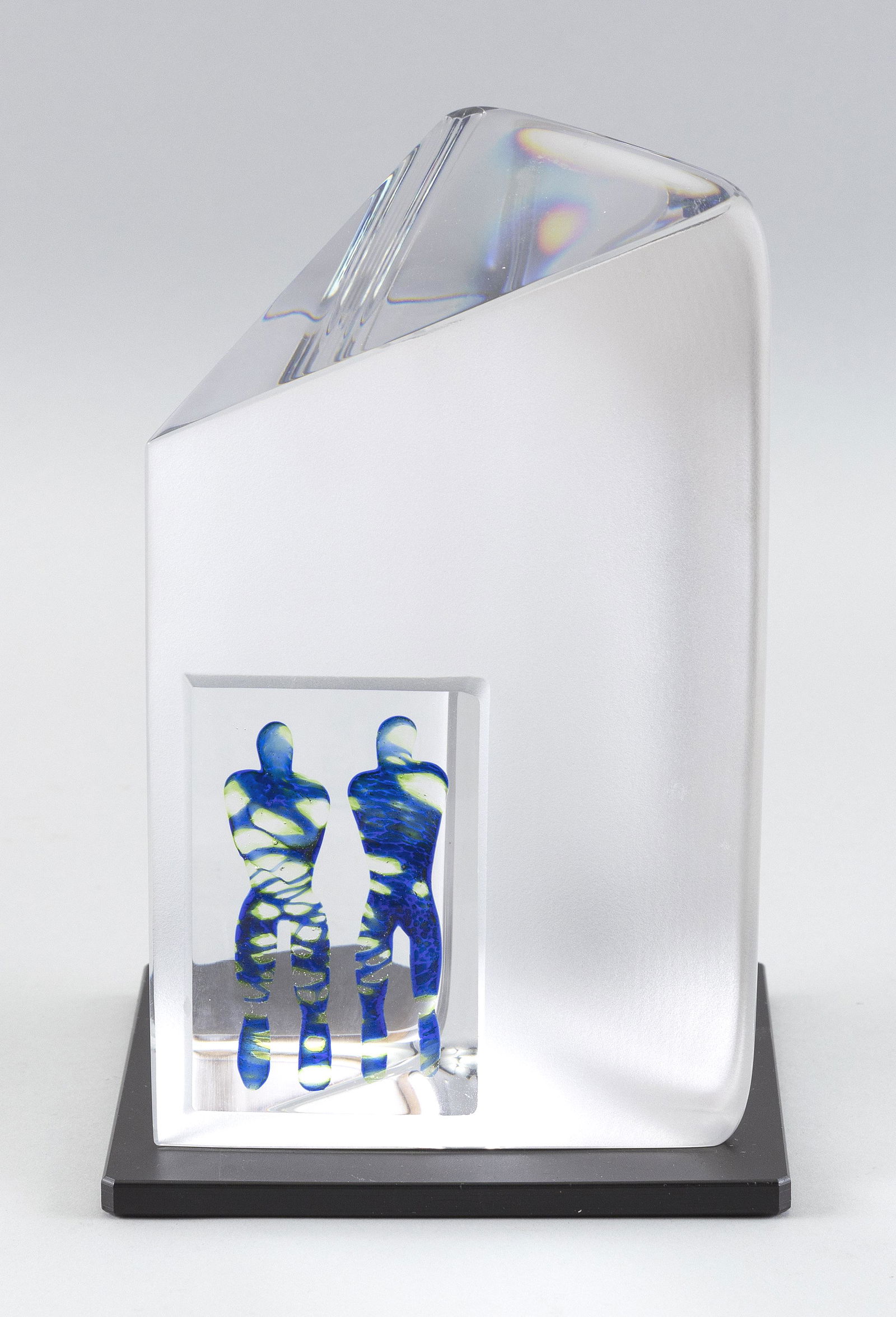 BERTIL VALLIEN FOR KOSTA BODA GLASS SCULPTURE: BERTIL VALLIEN FOR KOSTA BODA GLASS SCULPTURESweden, Mid-20th CenturyFormed as a triangular prism of clear crystal, with one frosted side featuring two cobalt blue figures. Signed and numbered 99519.