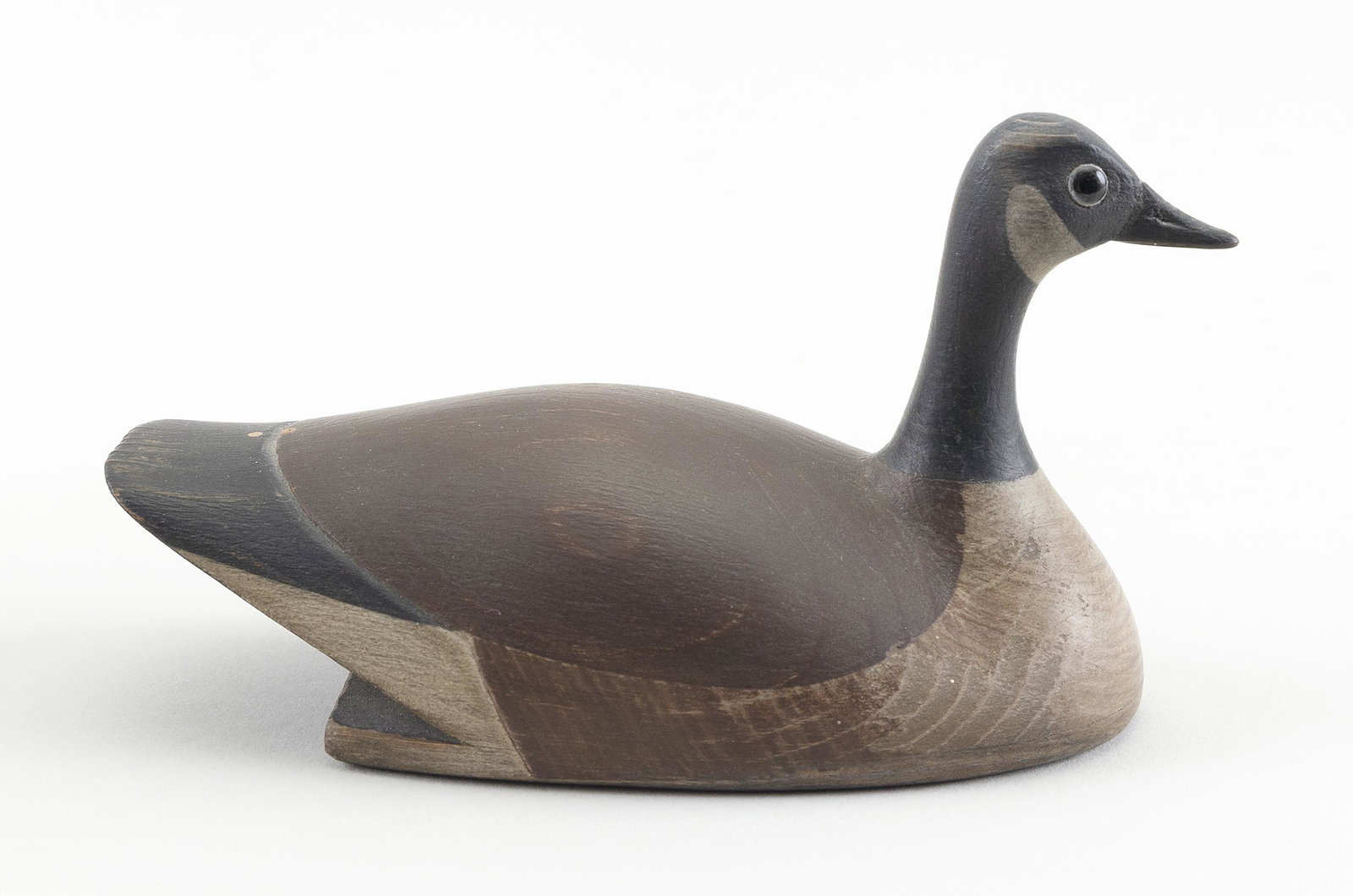 ALAN CHAFFEE MINIATURE SELF-BAILING CANADA GOOSE: ALAN CHAFFEE MINIATURE SELF-BAILING CANADA GOOSE Nantucket, Massachusetts, 20th Century Glass eyes. Carved “Chaffee" on underside. Length 5”.