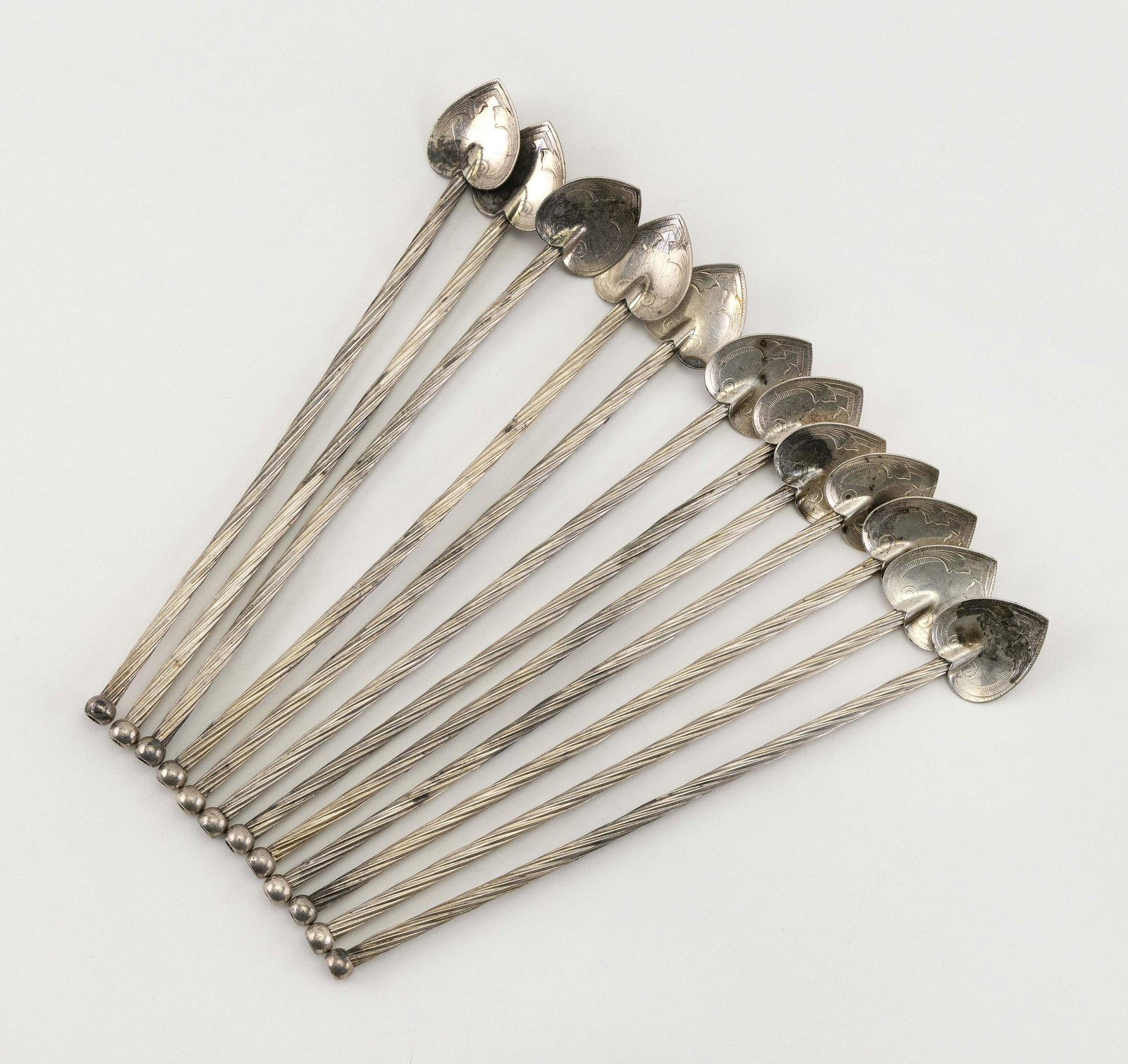 TWELVE STERLING SILVER SWIZZLE STICKS Mid-20th Century: TWELVE STERLING SILVER SWIZZLE STICKS Mid-20th Century Leaf-form stirrers and twisted straws. Lacking maker’s marks. Lengths 7.5”. Approx. 4.5 troy oz.