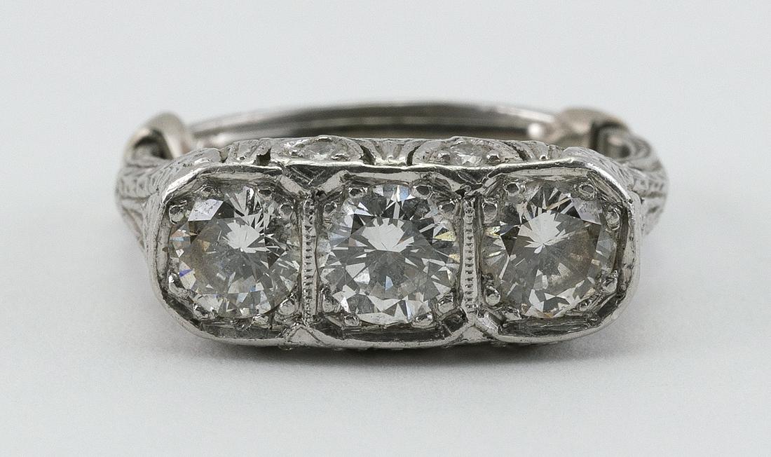 EDWARDIAN PLATINUM AND DIAMOND THREE-STONE RING Each (1 of 2)