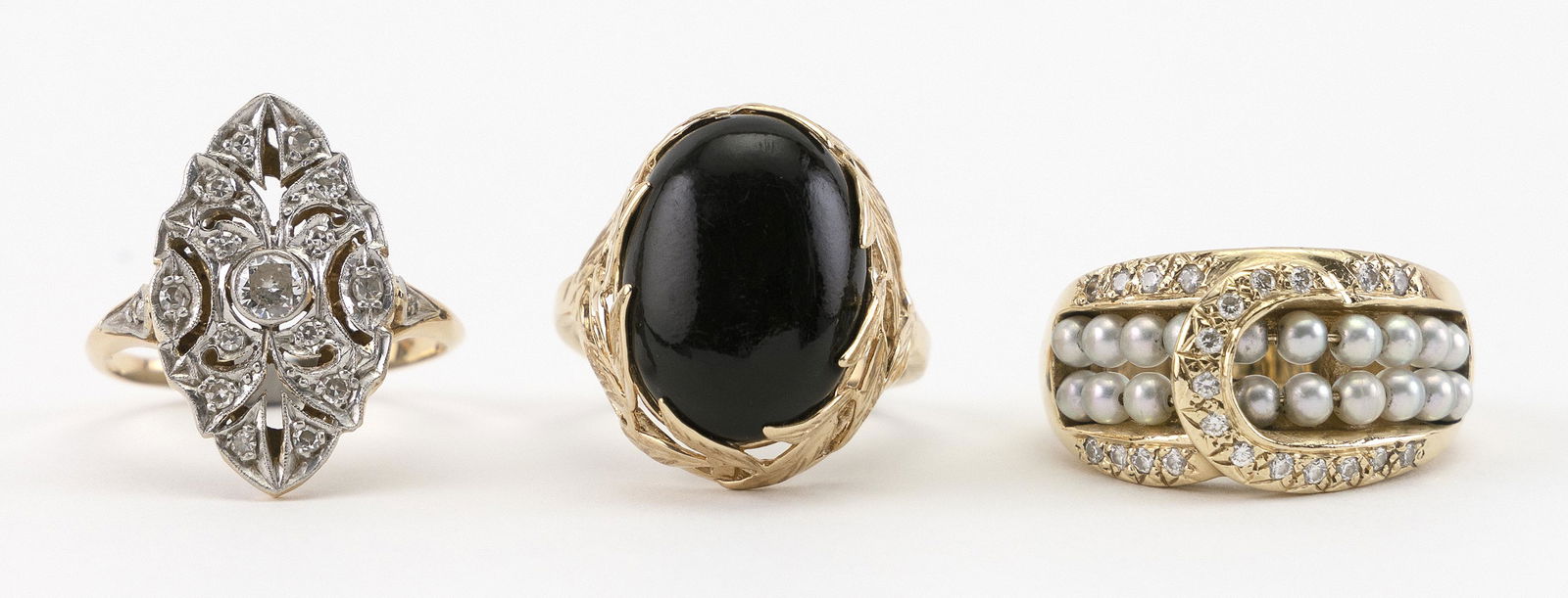 THREE 14KT GOLD RINGS 1) Navette ring set with (1 of 2)