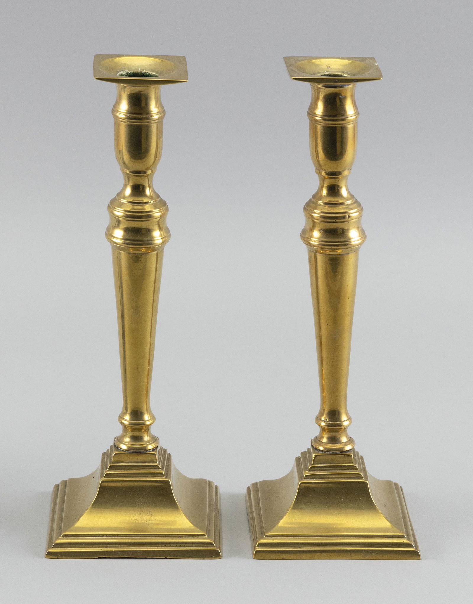 PAIR OF BRASS CANDLESTICKS First Half of the 19th: PAIR OF BRASS CANDLESTICKSFirst Half of the 19th CenturyReverse-tapered stems.Heights 9.5”. Provenance:Property of a direct descendant of Thomas Jefferson, the contents of the Brick House at Coolidg