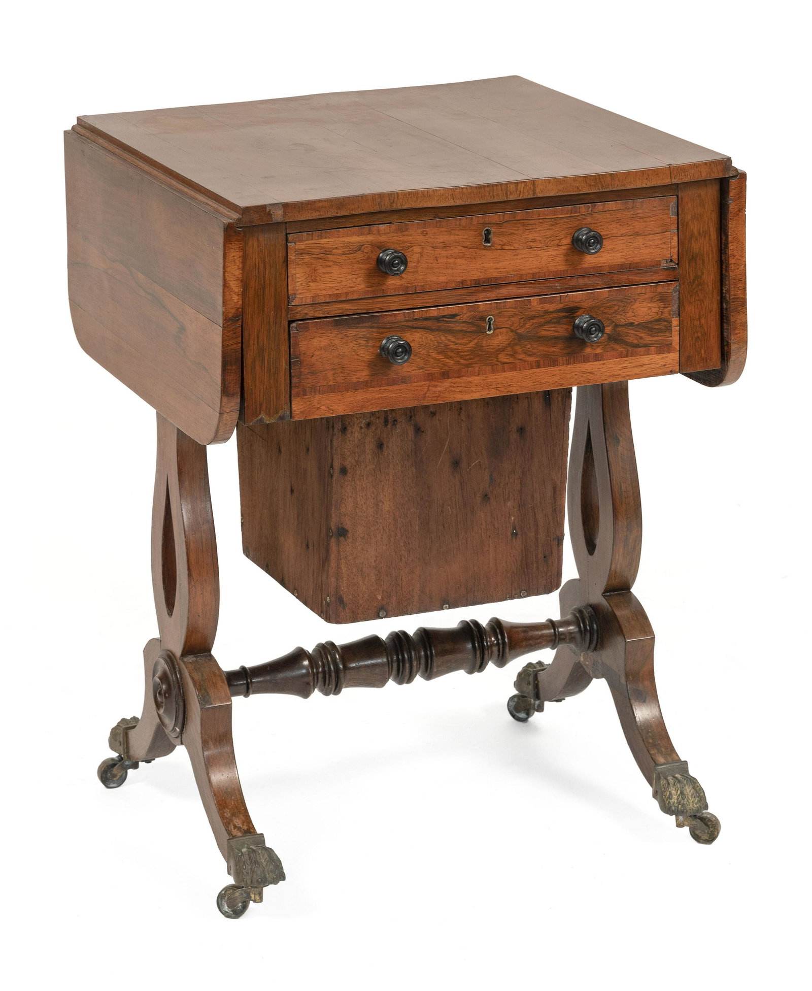 DROP-LEAF SEWING TABLE IN THE MANNER OF DUNCAN PHYFE: DROP-LEAF SEWING TABLE IN THE MANNER OF DUNCAN PHYFENew York, Circa 1820In rosewood veneer. Two drawers over a sewing basket, probably once covered with fabric. Four reverse-arched legs with brass-cap