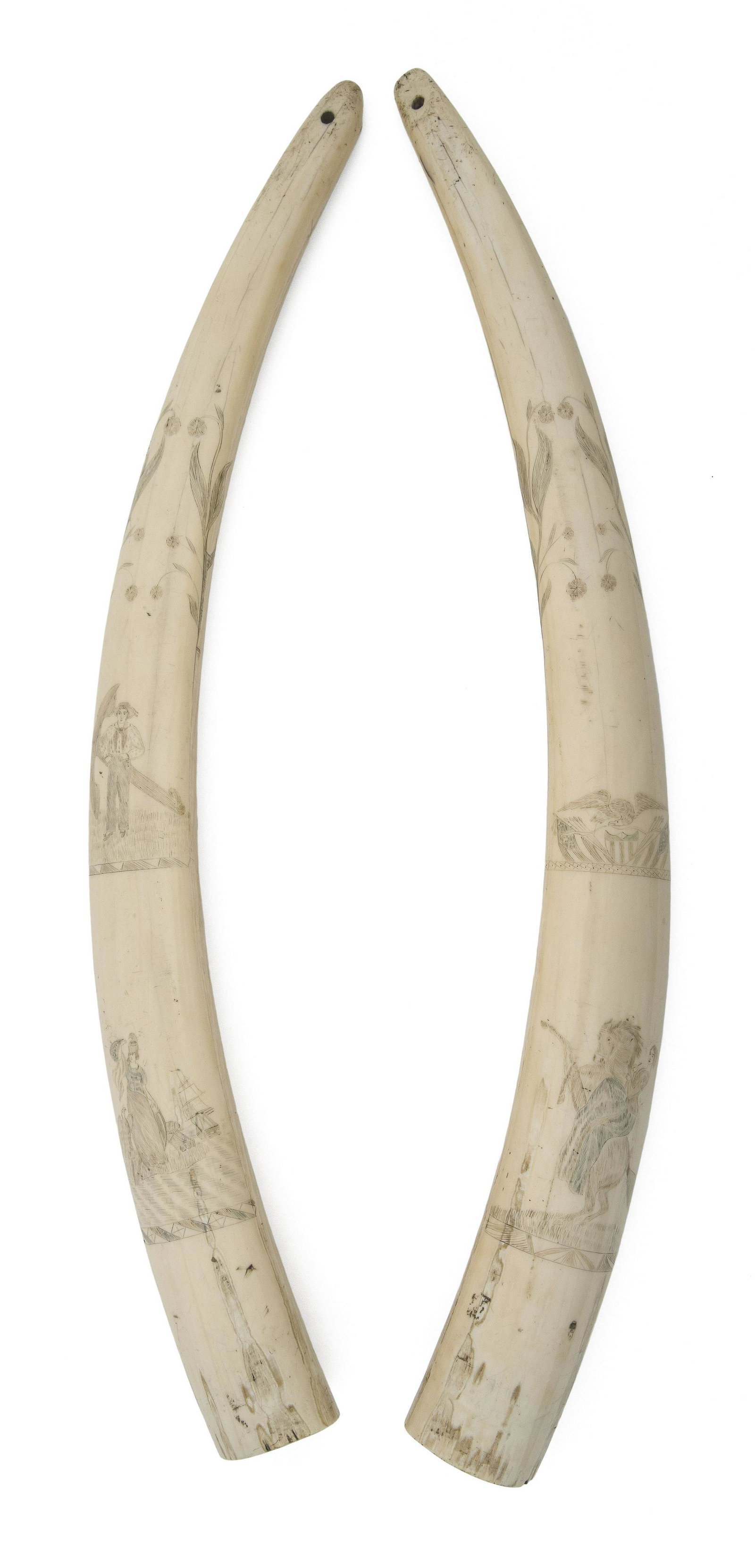 PAIR OF POLYCHROME SCRIMSHAW WALRUS TUSKS WITH: PAIR OF POLYCHROME SCRIMSHAW WALRUS TUSKS WITH PATRIOTIC MOTIFS Mid-19th Century Left tusk depicts two slender flower stems, a sailor standing by an anchor, and Lady Liberty by the shore, holding a fl