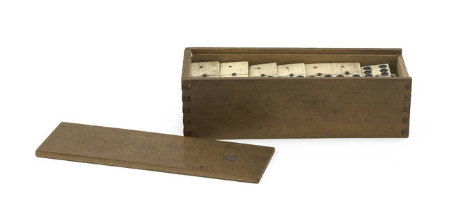 BOXED SET OF TWENTY-EIGHT EBONY AND IVORY DOMINOES: BOXED SET OF TWENTY-EIGHT EBONY AND IVORY DOMINOES 19th Century Ivory faces secured with brass pins. Original dovetailed wooden box with sliding lid. Pencil inscriptions on underside of box,