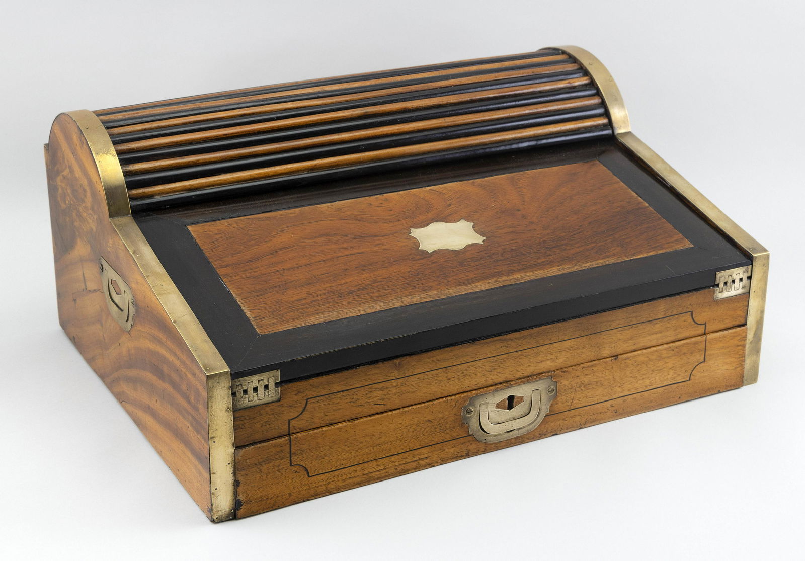 SEA CAPTAIN’S TAMBOUR ROLL-TOP DESK 19th Century Height: SEA CAPTAIN’S TAMBOUR ROLL-TOP DESK19th CenturyIn camphorwood, with brass fittings.Height 8.5”. Width 19.5”. Depth 15”.
