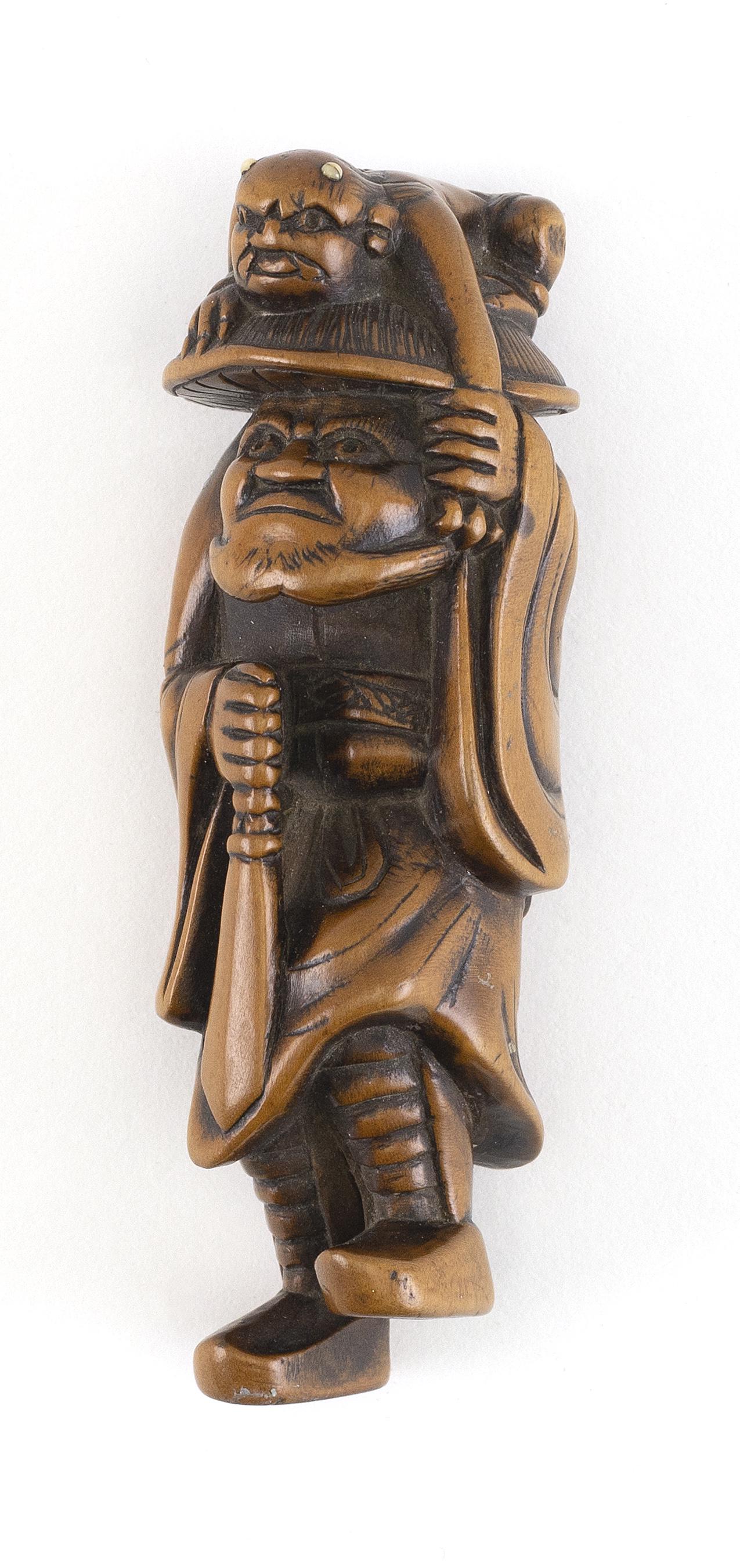 JAPANESE WOOD NETSUKE 19th Century Height 3.25".: JAPANESE WOOD NETSUKE 19th Century Shoki holding an oni that has tried to hide on Shoki's hat. Height 3.25". Provenance: Eldred's, August 25, 1999, Lot #1217. The Collection of Gloria and Joe Kur