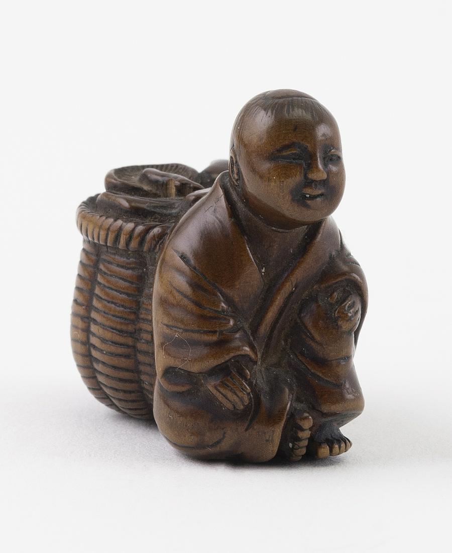 JAPANESE WOOD NETSUKE Meiji Period Length 1".: JAPANESE WOOD NETSUKE Meiji Period A robed man seated with a basket of mushrooms. Length 1". Provenance: Private Wisconsin Collection.