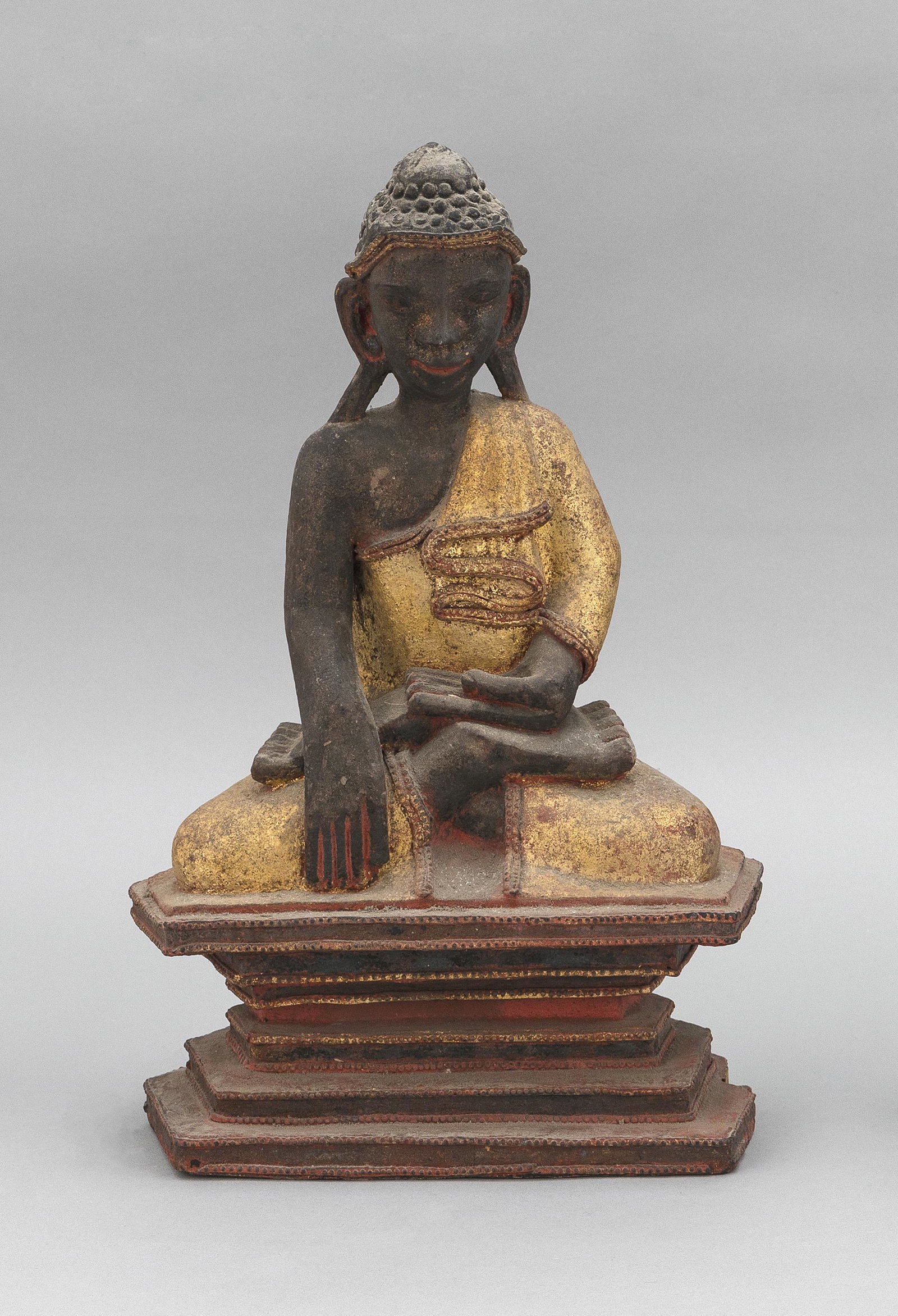 BURMESE GILT AND RED WOOD BUDDHA Late 19th/Early 20th: BURMESE GILT AND RED WOOD BUDDHA Late 19th/Early 20th Century Seated in earth-touching position on a tiered base. Height 15".