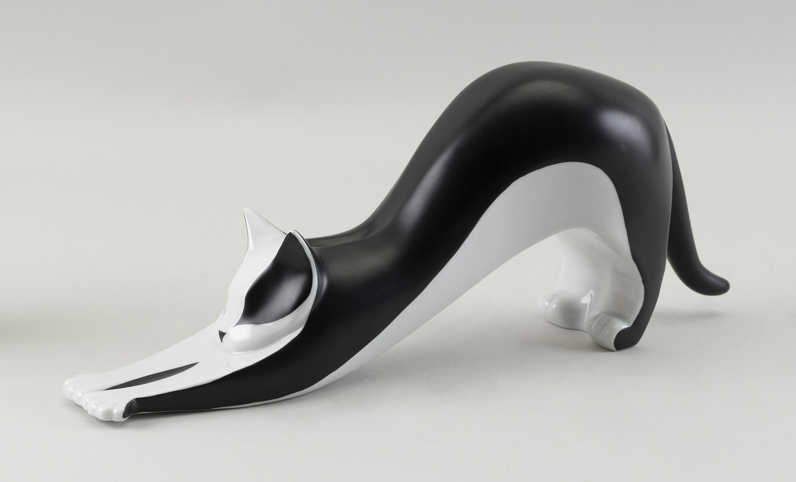 ROYAL DUX PORCELAIN MODERNIST FIGURE OF A STRETCHING: ROYAL DUX PORCELAIN MODERNIST FIGURE OF A STRETCHING CATIn black and white. Factory marks.Length 12.5”.