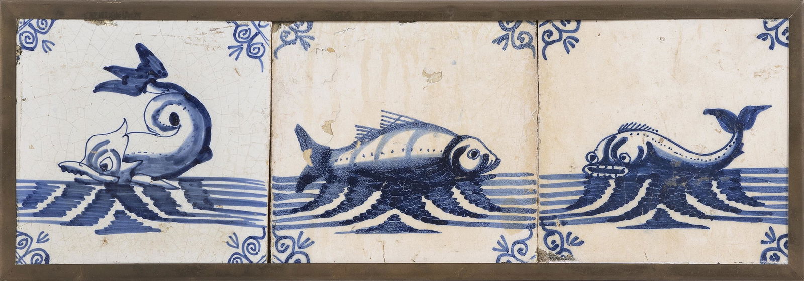 THREE BLUE AND WHITE DELFT TILES SET IN A BRASS FRAME (1 of 2)