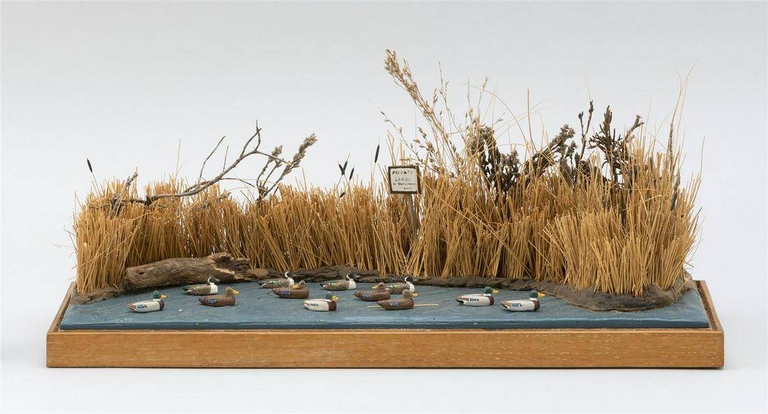 A.C. GOULD WATERFOWL DIORAMA 20th Century Height 6.5".: A.C. GOULD WATERFOWL DIORAMA 20th Century Eleven miniature decoys in a pond. Height 6.5". Width 15". Depth 6".