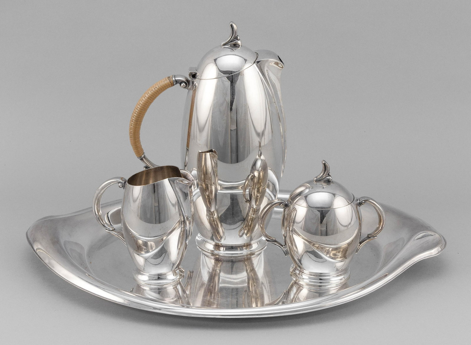 1847 ROGERS BROTHERS/INTERNATIONAL SILVER FOUR-PIECE: 1847 ROGERS BROTHERS/INTERNATIONAL SILVER FOUR-PIECE "FLAIR" MODERNIST SILVER PLATED COFFEE SERVICE Circa 1956 Consists of a coffeepot with wrapped handle, height 10.25", a covered suga