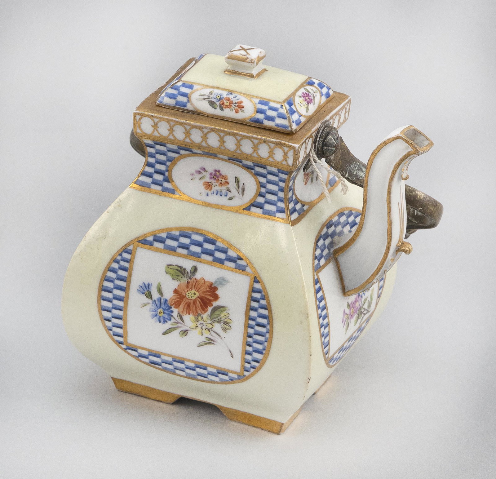 MEISSEN MARCOLINI PERIOD PORCELAIN TEAPOT Germany,: MEISSEN MARCOLINI PERIOD PORCELAIN TEAPOT Germany, Circa 1774-1814 Squat, squared body hand-painted with flower sprays and blue checkered medallions against a pale yellow ground. Brass handle with por
