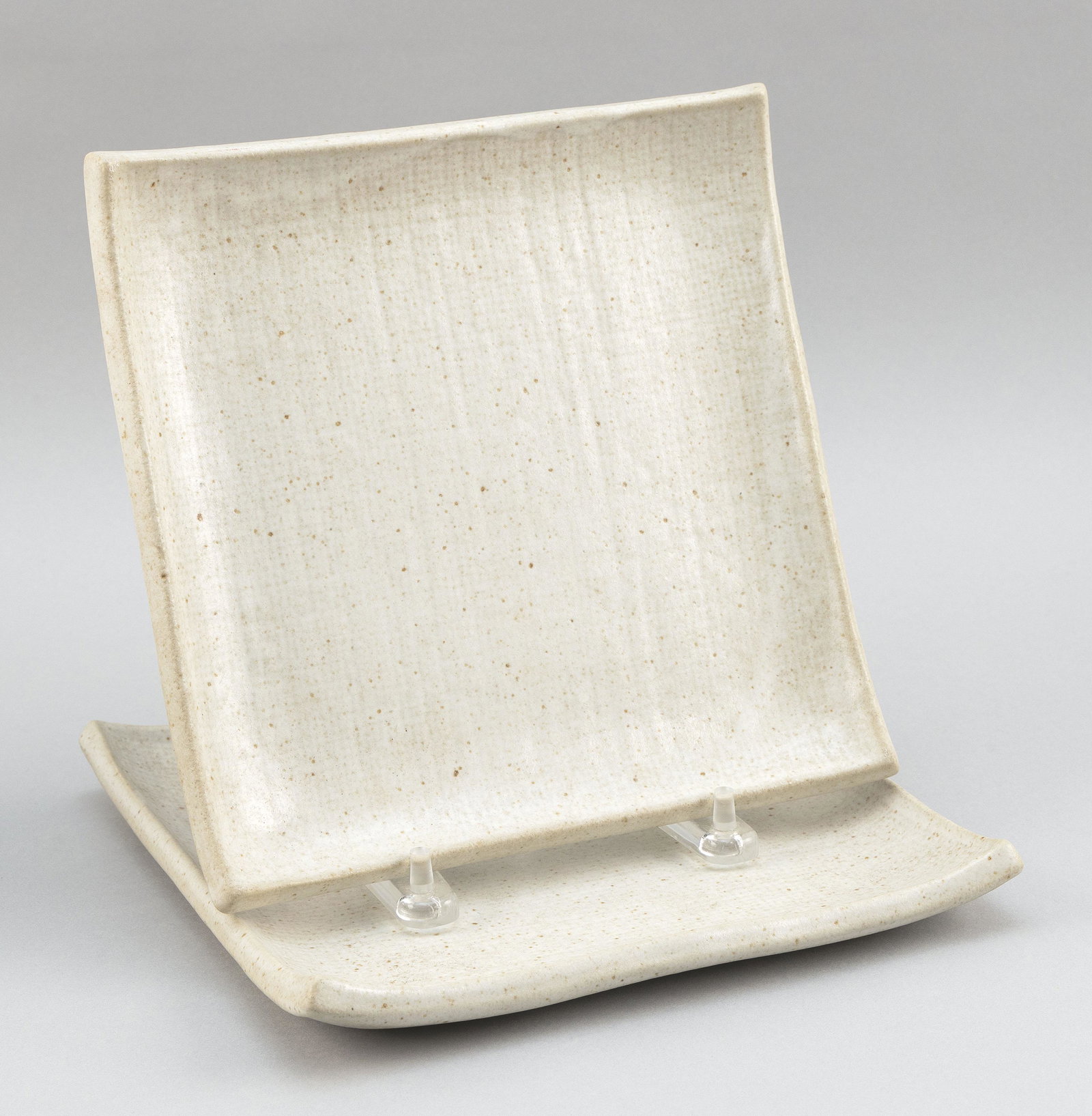 TWO JAPANESE STUDIO POTTERY CREAM GLAZE PLATES . (1 of 3)