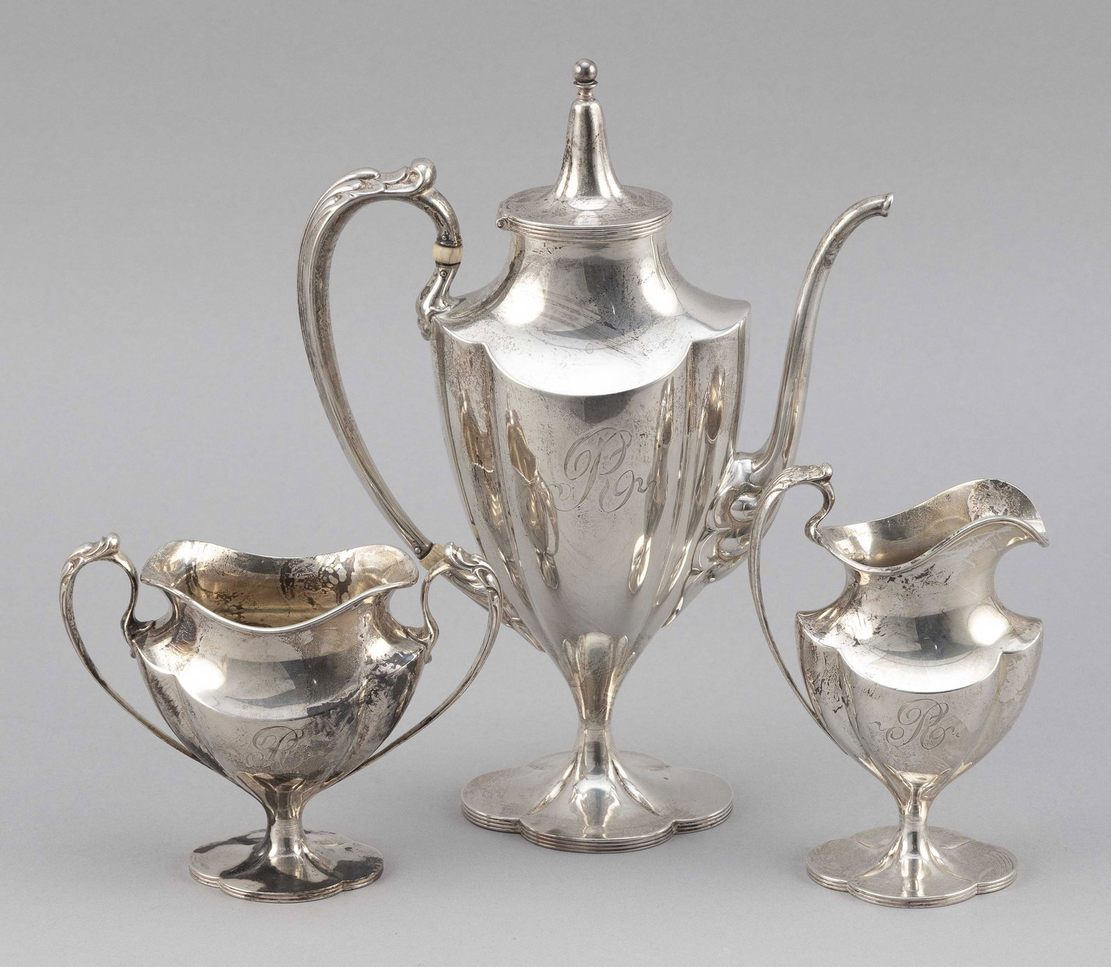 INTERNATIONAL TETE-A-TETE STERLING SILVER TEA SERVICE: INTERNATIONAL TETE-A-TETE STERLING SILVER TEA SERVICE Includes a teapot, height 9", a creamer and an open sugar bowl. Monogrammed. Approx. 16.4 troy oz.